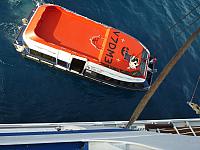 Hooking up the tender to lift it aboard the ship