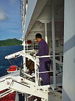 Crewman awaits the tender (next to our veranda)